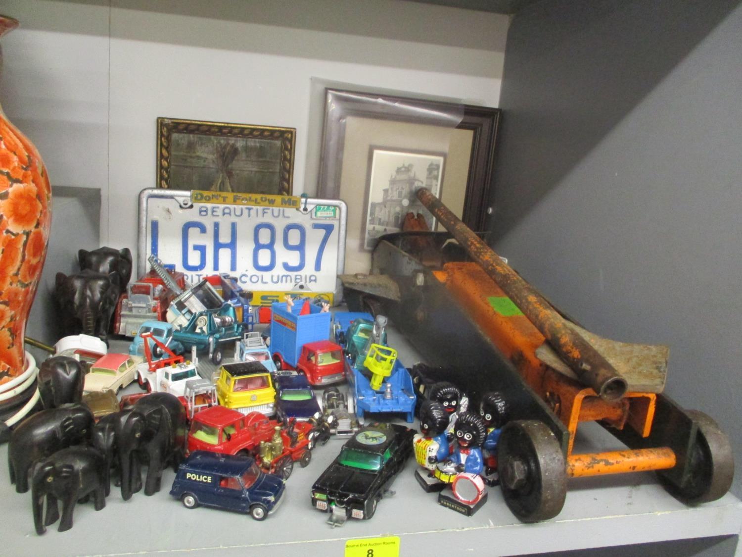 A mixed lot to include a trolley jack, pictures, elephant ornaments, Robertson Golly figures, and