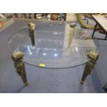 A modern glass topped coffee table having four French style tapering legs