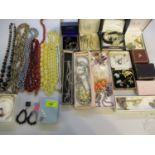 A quantity of late 20th century costume jewellery to include a yellow metal horseshoe pin badge, and