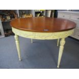 A circular hardwood dining table of French style, turned, tapered fluted legs and matching