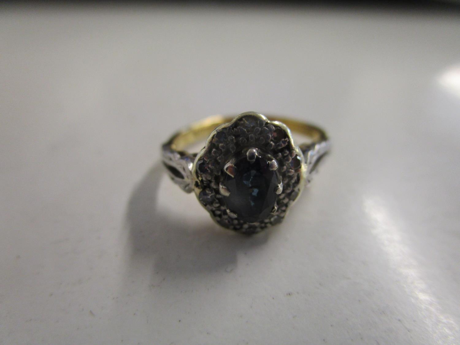 An 18ct gold and platinum sapphire and diamond cluster ring. Location:Cab