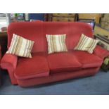 A three seater sofa, two armchairs and a footstool
