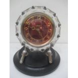 A Vintage Russian glass mantle clock having a red dial inscribed Masik, with Arabic numerals and