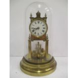 A late 19th/early 20th century Gustav Becker brass anniversary clock under a glass dome. The