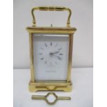 A Mappin & Webb brass repeater carriage clock having white enamel dial with Roman numerals and