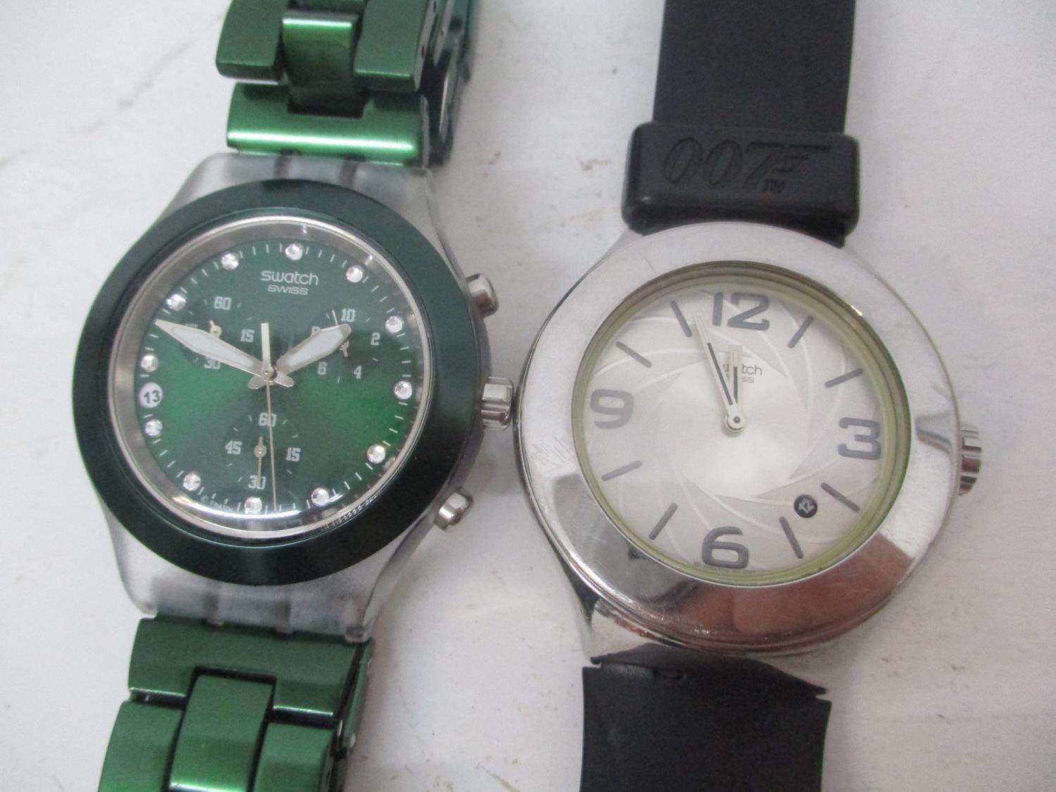 Two Swatch Irony gents wristwatches to include a 007 stainless steel watch on a black leather strap,