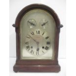 An early 20th century mahogany arched top bracket clock. The silvered dial having Roman numerals,