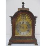 A late 19th/early 20th century walnut bracket clock. The dial having a matted centre, silvered