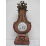 A late 19th century French pink marble and gilt metal lyre shaped clock in the Louis XV1 style.