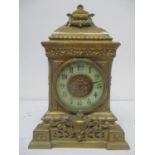 A late 19th century French ornate brass mantle/timepiece clock having twin carrying handles above