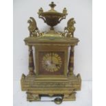 A late 19th century French Empire style gilt brass mantle clock. The case having an urn shaped