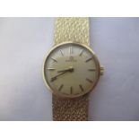 An Omega ladies 9ct gold, manual wind wristwatch. The gilt coloured dial having baton markers and