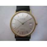 A Geneve gents 9ct gold quartz wristwatch having a silvered dial, gilt baton markers and hands, date