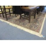 A Ferraghan woollen carpet with multiguard borders, cream ground with navy and red decoration,