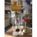 Four early to mid 20th century oil lamps