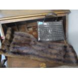 A mink fur wrap together with a vintage black crocodile skin handbag