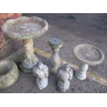 A selection of stoneware garden ornaments to include two eagles, two bird baths and a sundial