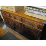 A reproduction large oak carved sideboard having three drawers above three cupboards, 36" h x 66"w