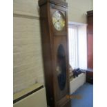 A 1930s oak long case clock with a silvered Arabic dial and visible pendulum