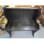 A modern black painted bench with a planked back 37 1/2" x 34 3/4" x 16 5/8"