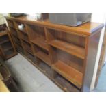 A large stained pine open bookcase on a plinth base, 47 1/2" h x 103 1/2"w