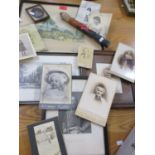 A quantity of prints and early 20th century photographs, together with a small carved and painted