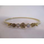 A 9ct gold opal inset bangle