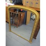A Victorian moulded plaster arched over-mantle mirror