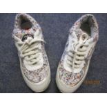 A pair of trainers in the style of a French fashion house, having multi-coloured boucle fabric and