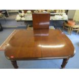 A Victorian mahogany wind-out dining table on turned legs and castors, with one extra leaf 28" x