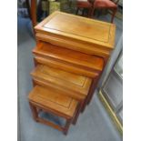 A modern Oriental rosewood nest of four tables 27"h x 20"w