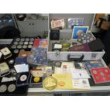 A collection of silver commemorative coins and others to include an 1881 silver USA one dollar coin,