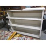 A modern grey painted three tier open bookcase, 40"h x 54 1/2"w