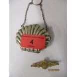 A silver shell shaped small purse, together with a yellow metal brooch