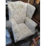 A large Georgian style wing back armchair