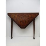 A 19th century Dutch walnut and marquetry folding card table, with a triangular top, on square