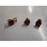 A 10ct gold and ruby pendant and matching 9ct gold ear studs