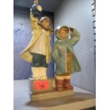 A Lladro figural group of two young boys looking out to sea