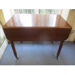 A Victorian mahogany Pembroke table having an inset drawer and turned legs 27 3/4"h x 34"w
