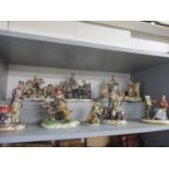A collection of four Capodimonte figures to include a lady sat painting, signed B Merlin A/F,