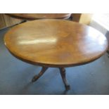 A Victorian walnut oval topped loo table having marquetry inlaid top, and standing on four