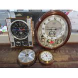 A Small World Rhythm Clock, a Spirit of St Louis Clock, a barometer and another clock