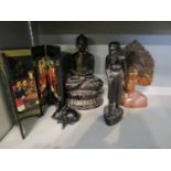 A group of carved wooden Asian busts and an oriental folding table screen