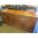 A modern Oriental rosewood sideboard having four drawers, cupboards and on a plinth base 34"h x 71