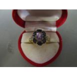 A 10ct gold sapphire, diamond and amethyst set cluster ring