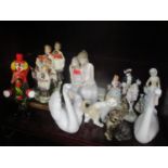 A mixed lot to include two Lladro swans, Lladro figure group of two seated girls, a Murano clown and