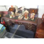 A late Victorian mahogany inlaid writing desk having a green leather topped scriber, inset drawers