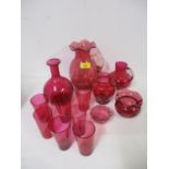 A selection of cranberry glassware to include a jug and six glasses