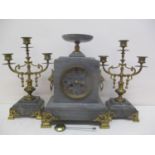 A 19th century French marble and gilt metal mantle clock with two matching garnitures. The clock