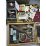 A mixed lot of collectables to include badges, buttons, silver charms, handcuffs and other items